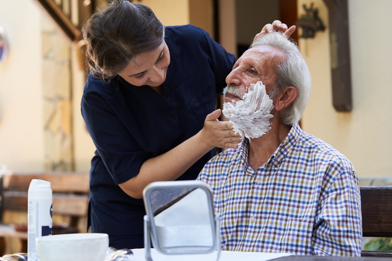 Caregiver assisting with personal grooming